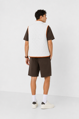 Second lifestyle view of a model wearing a white Bay or Bust Anthropic signature vest