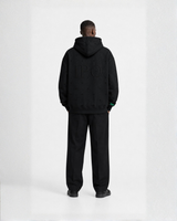 Model wearing a black Bay or Bust OpenAI signature hoodie, back view for the IPO Collection