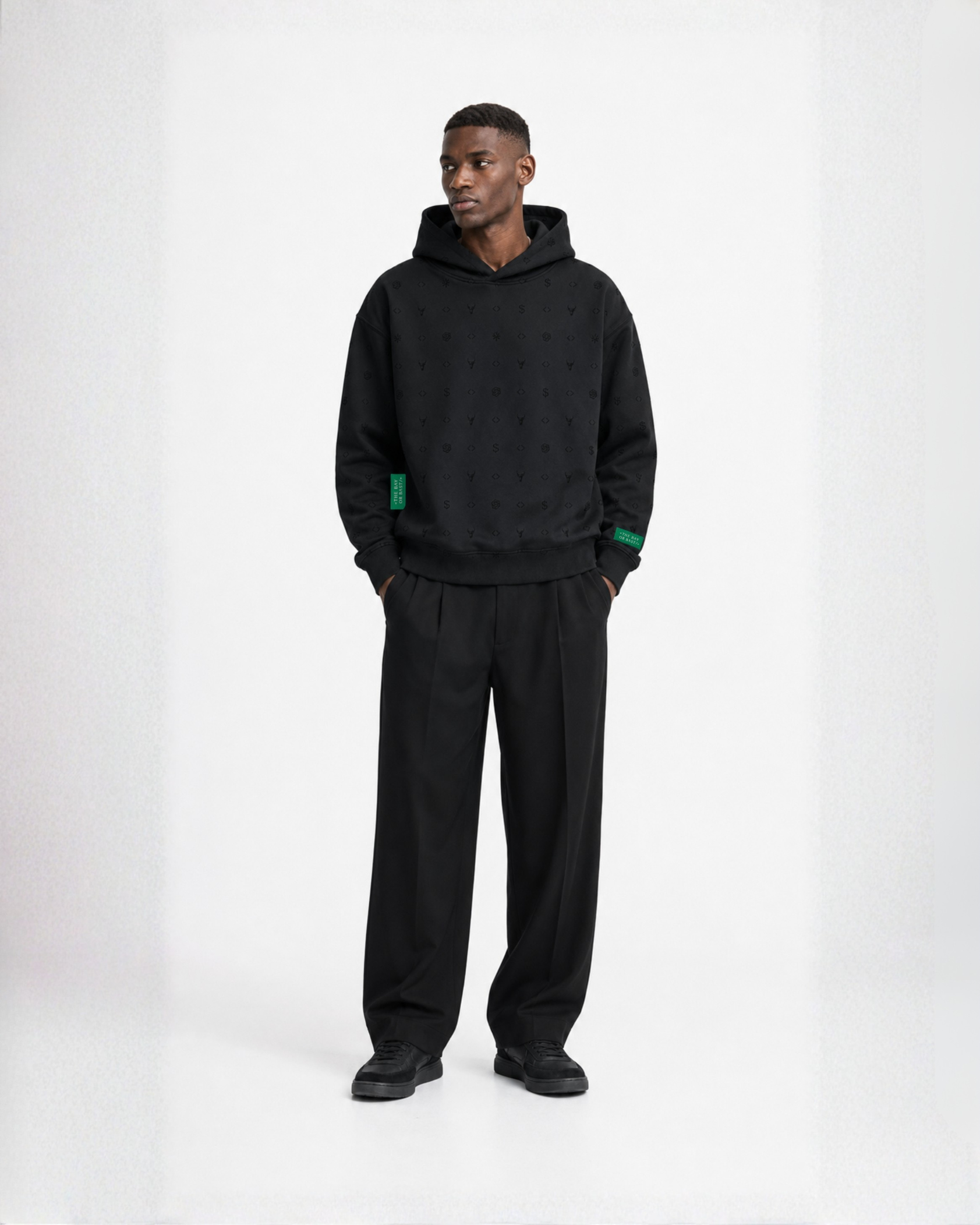 Model wearing a black Bay or Bust OpenAI signature hoodie, front view for the IPO Collection