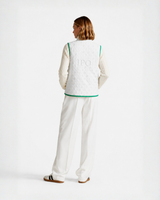 Model wearing a white Bay or Bust OpenAI signature vest, back view for the IPO Collection